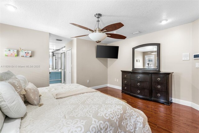 14288 SW 21st Ter, Miami, FL 33175 - bedroom with wood finished floors, a textured ceiling, a ceiling fan, and ensuite bath