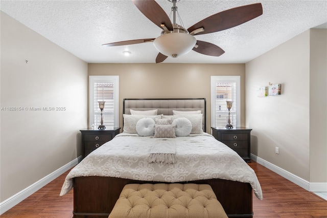 14288 SW 21st Ter, Miami, FL 33175 - bedroom featuring multiple windows, a textured ceiling, dark wood-type flooring, and a ceiling fan