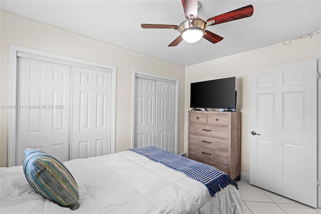 14288 SW 21st Ter, Miami, FL 33175 - bedroom with two closets, light tile patterned flooring, and a ceiling fan