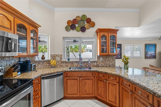 14288 SW 21st Ter, Miami, FL 33175 - kitchen with stainless steel appliances, a ceiling fan, crown molding, tasteful backsplash, and light stone countertops