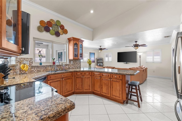 14288 SW 21st Ter, Miami, FL 33175 - kitchen featuring brown cabinetry, tasteful backsplash, a peninsula, crown molding, and a breakfast bar area