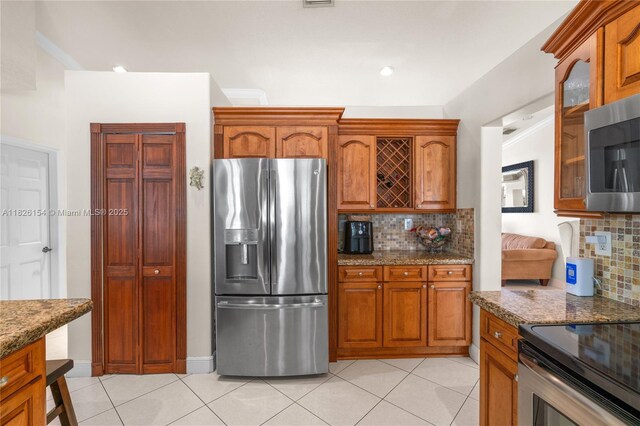 14288 SW 21st Ter, Miami, FL 33175 - kitchen featuring appliances with stainless steel finishes, light tile patterned floors, decorative backsplash, and glass insert cabinets