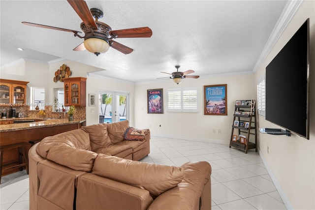 14288 SW 21st Ter, Miami, FL 33175 - living room with light tile patterned floors, healthy amount of natural light, ceiling fan, a textured ceiling, and ornamental molding