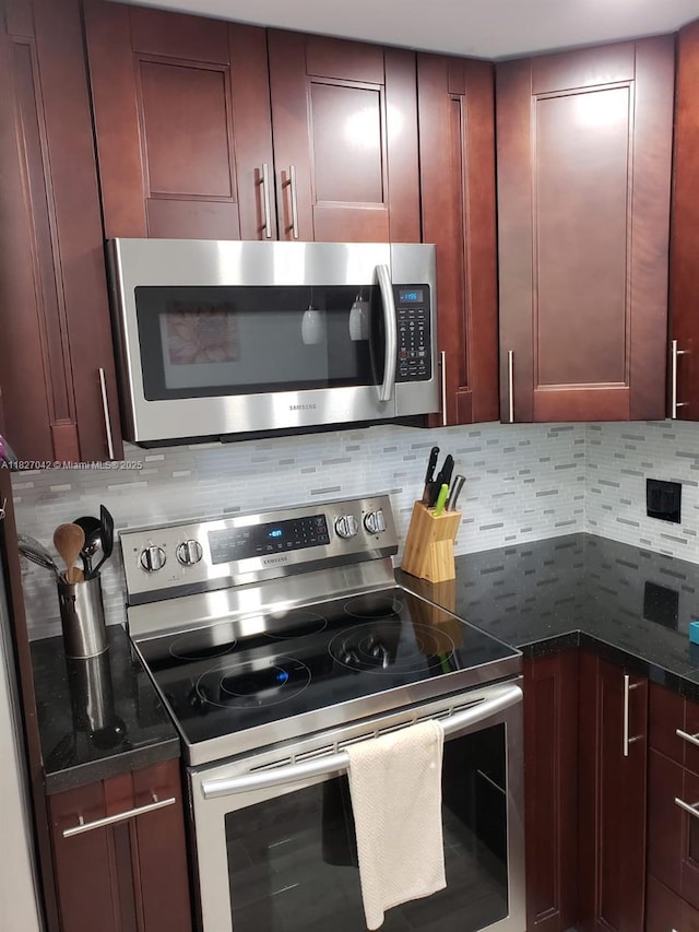 900 NE 12th Ave Unit 302, Hallandale Beach, FL 33009 - kitchen with appliances with stainless steel finishes, tasteful backsplash, and reddish brown cabinets
