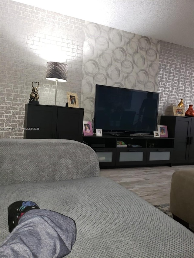 900 NE 12th Ave Unit 302, Hallandale Beach, FL 33009 - living area with wood finished floors and brick wall