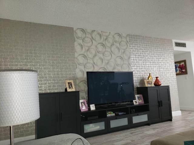900 NE 12th Ave Unit 302, Hallandale Beach, FL 33009 - living area featuring a textured ceiling and wood finished floors