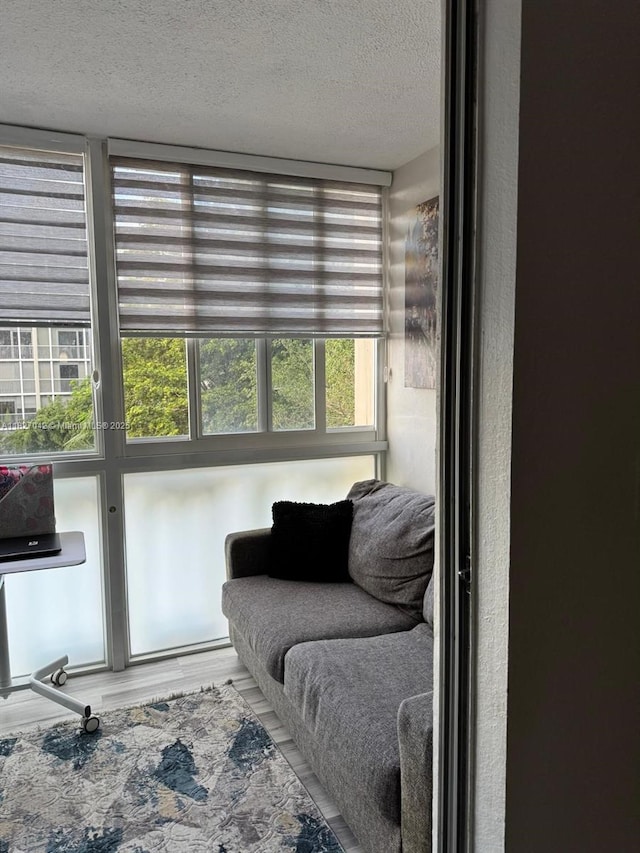 900 NE 12th Ave Unit 302, Hallandale Beach, FL 33009 - living room featuring a textured ceiling and wood finished floors