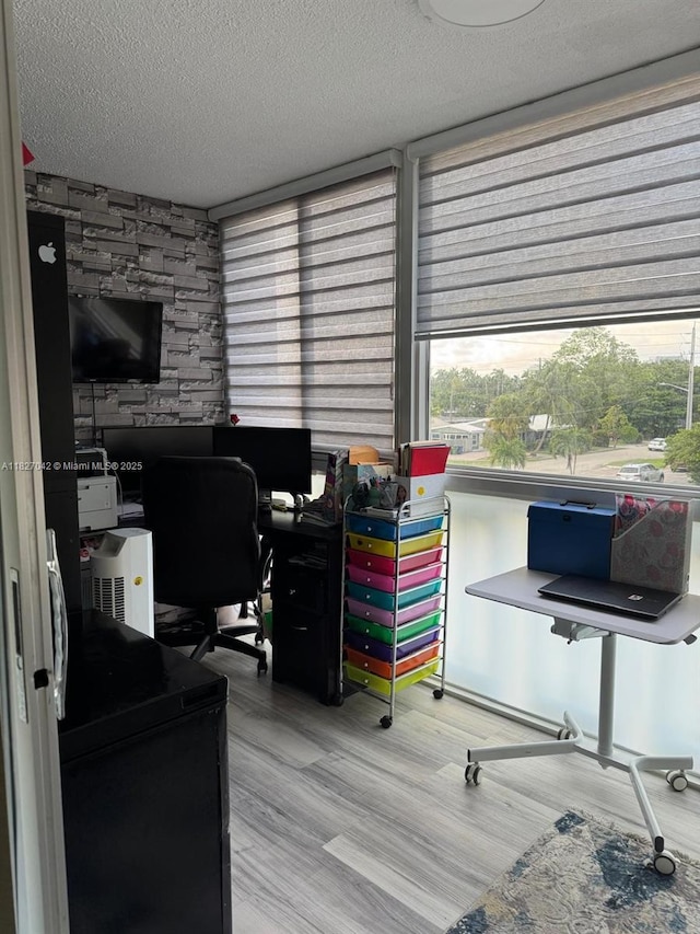 900 NE 12th Ave Unit 302, Hallandale Beach, FL 33009 - home office with a textured ceiling and wood finished floors