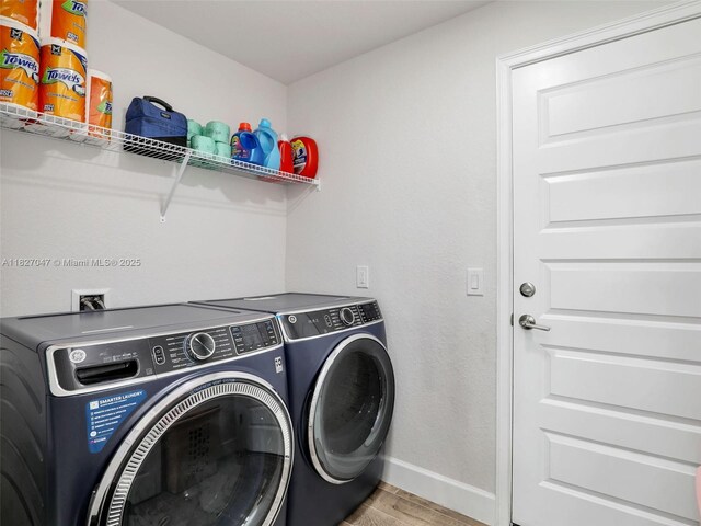 2405 Nelson Rd, Cape Coral, FL 33993 - washroom featuring washer and clothes dryer and light wood-style floors