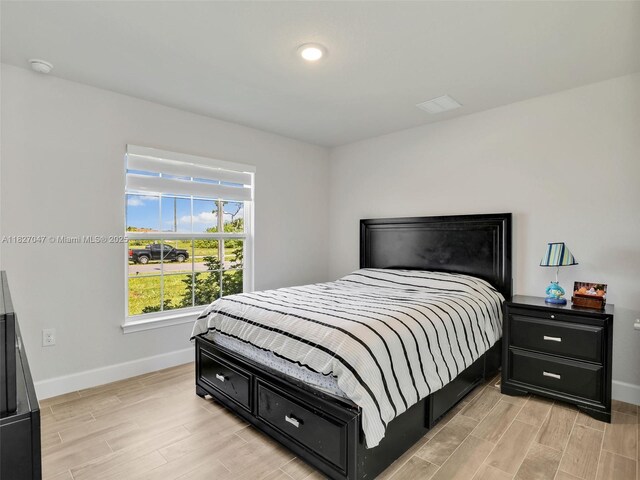 2405 Nelson Rd, Cape Coral, FL 33993 - bedroom with baseboards and light wood-style floors