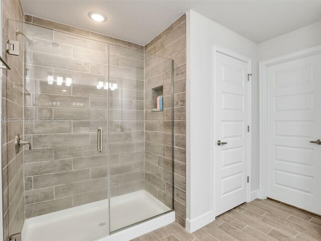 2405 Nelson Rd, Cape Coral, FL 33993 - full bath featuring a shower stall and wood tiled floors