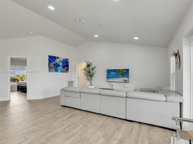 2405 Nelson Rd, Cape Coral, FL 33993 - living area featuring lofted ceiling, light wood-type flooring, and recessed lighting