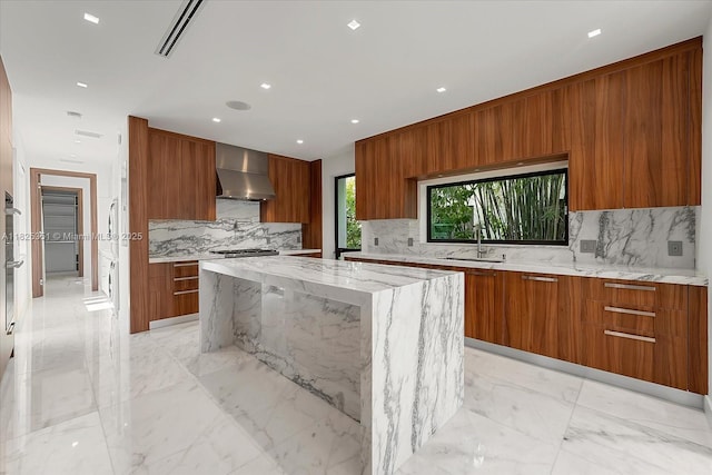 1311 Stillwater Dr, Miami Beach, FL 33141 - kitchen featuring modern cabinets, wall chimney exhaust hood, brown cabinetry, decorative backsplash, and recessed lighting