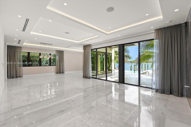 1311 Stillwater Dr, Miami Beach, FL 33141 - empty room with a tray ceiling and light marble finish floors
