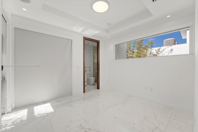 1311 Stillwater Dr, Miami Beach, FL 33141 - unfurnished room with light marble finish floors and a raised ceiling