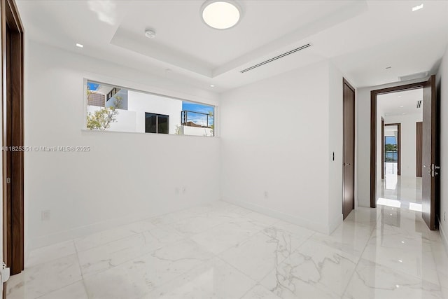 1311 Stillwater Dr, Miami Beach, FL 33141 - spare room featuring healthy amount of natural light, light marble finish flooring, and a smoke detector