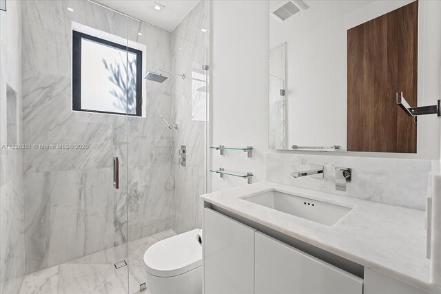 1311 Stillwater Dr, Miami Beach, FL 33141 - bathroom featuring a marble finish shower and vanity