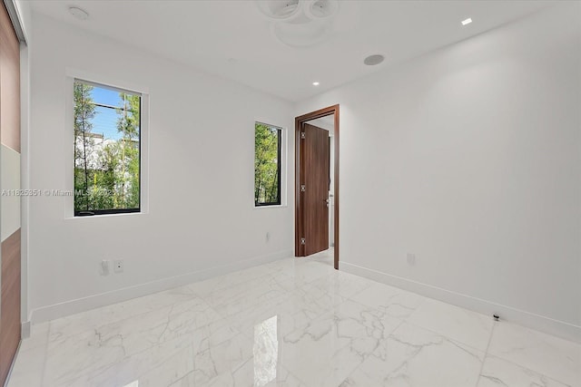 1311 Stillwater Dr, Miami Beach, FL 33141 - unfurnished room featuring light marble finish floors, a smoke detector, and recessed lighting