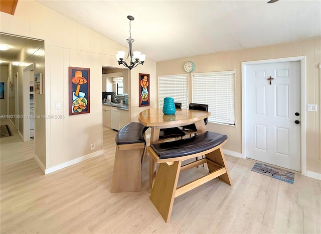 211 Banyan Ln, Tavernier, FL 33070 - dining space featuring light wood-style flooring, vaulted ceiling, and a chandelier