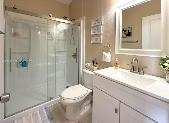 211 Banyan Ln, Tavernier, FL 33070 - bathroom featuring a shower stall, vanity, tile walls, and backsplash