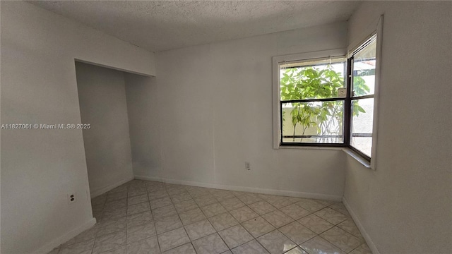1105 San Remo Cir, Homestead, FL 33035 - empty room with a textured ceiling and light tile patterned floors