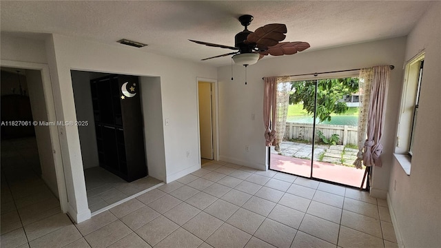 1105 San Remo Cir, Homestead, FL 33035 - unfurnished bedroom featuring access to exterior, a textured ceiling, light tile patterned floors, a ceiling fan, and a closet