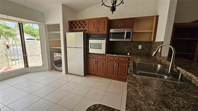 1105 San Remo Cir, Homestead, FL 33035 - kitchen with white appliances, open shelves, washer / clothes dryer, tasteful backsplash, and light tile patterned floors