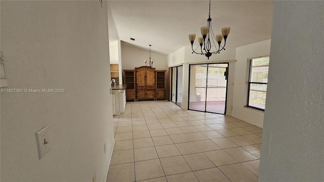 1105 San Remo Cir, Homestead, FL 33035 - unfurnished dining area featuring a chandelier, lofted ceiling, light tile patterned floors, and a textured wall