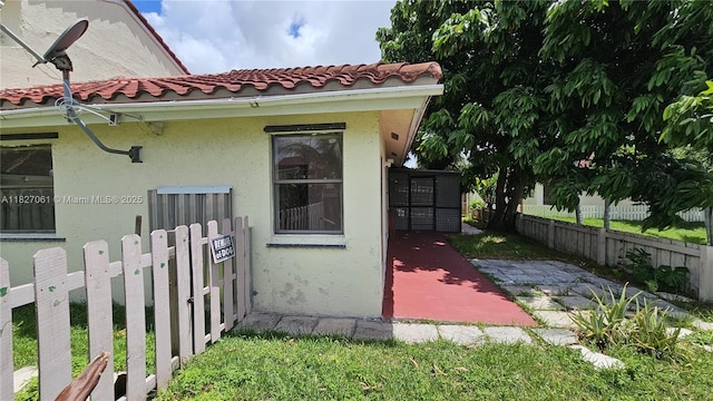 1105 San Remo Cir, Homestead, FL 33035 - view of side of property featuring a tiled roof and stucco siding
