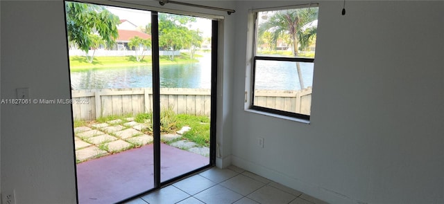 1105 San Remo Cir, Homestead, FL 33035 - doorway with healthy amount of natural light, tile patterned floors, and a water view