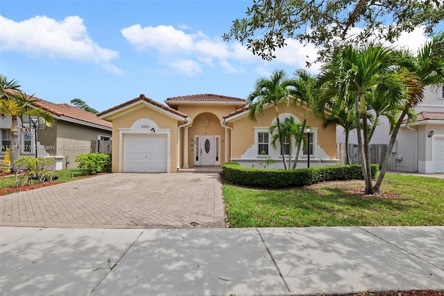 13011 SW 143rd Ter, Miami, FL 33186 - mediterranean / spanish home featuring decorative driveway, stucco siding, a garage, and a tile roof