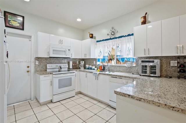 13011 SW 143rd Ter, Miami, FL 33186 - kitchen with white appliances, tasteful backsplash, light stone countertops, white cabinetry, and recessed lighting