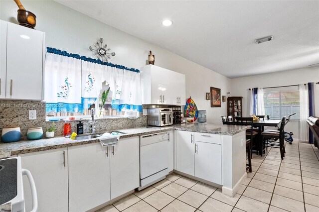 13011 SW 143rd Ter, Miami, FL 33186 - kitchen with dishwasher, range, white cabinetry, a peninsula, and light tile patterned flooring