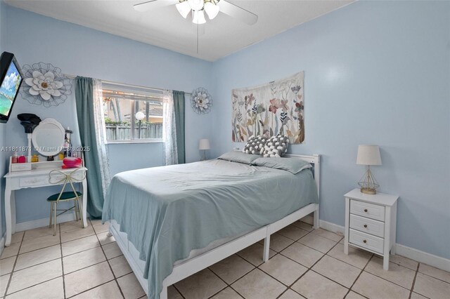 13011 SW 143rd Ter, Miami, FL 33186 - bedroom with light tile patterned floors and a ceiling fan
