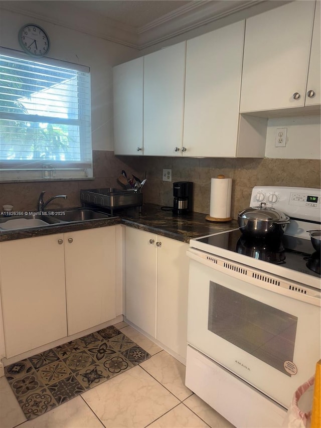 8821 W Flagler St Unit 108, Miami, FL 33174 - kitchen with white electric stove, ornamental molding, backsplash, white cabinetry, and light tile patterned flooring