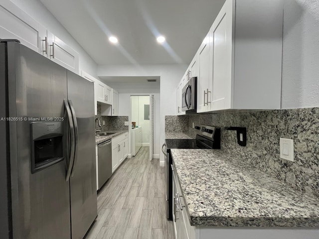 1710 NW 92nd Ave, Pembroke Pines, FL 33024 - kitchen with appliances with stainless steel finishes, tasteful backsplash, white cabinets, recessed lighting, and light stone counters