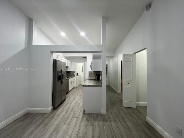 1710 NW 92nd Ave, Pembroke Pines, FL 33024 - kitchen featuring appliances with stainless steel finishes, white cabinetry, light wood-style flooring, tasteful backsplash, and high vaulted ceiling