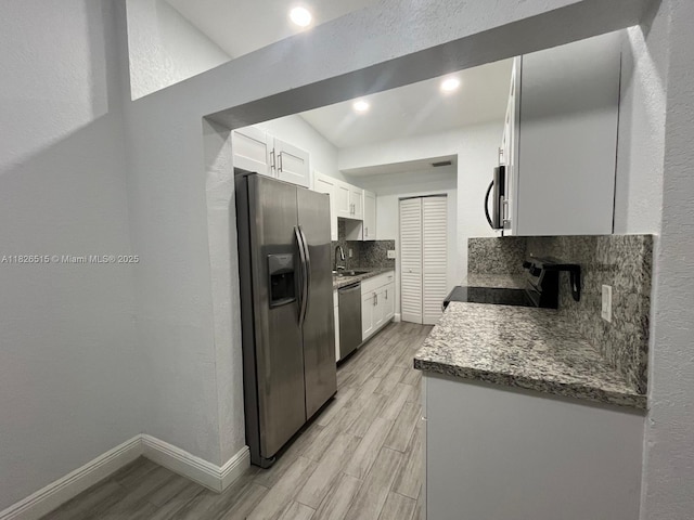 1710 NW 92nd Ave, Pembroke Pines, FL 33024 - kitchen featuring stainless steel appliances, light wood-style flooring, white cabinets, tasteful backsplash, and recessed lighting