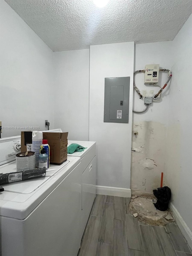 1710 NW 92nd Ave, Pembroke Pines, FL 33024 - laundry room with electric panel, wood tiled floors, washer and clothes dryer, and a textured ceiling