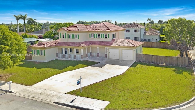 32157 SW 207th Ave, Homestead, FL 33030 - mediterranean / spanish house featuring stucco siding, covered porch, a tiled roof, concrete driveway, and a residential view