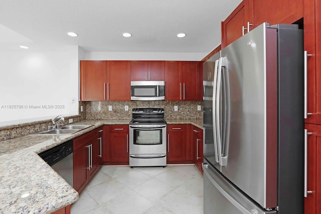32157 SW 207th Ave, Homestead, FL 33030 - kitchen with appliances with stainless steel finishes, reddish brown cabinets, tasteful backsplash, and recessed lighting