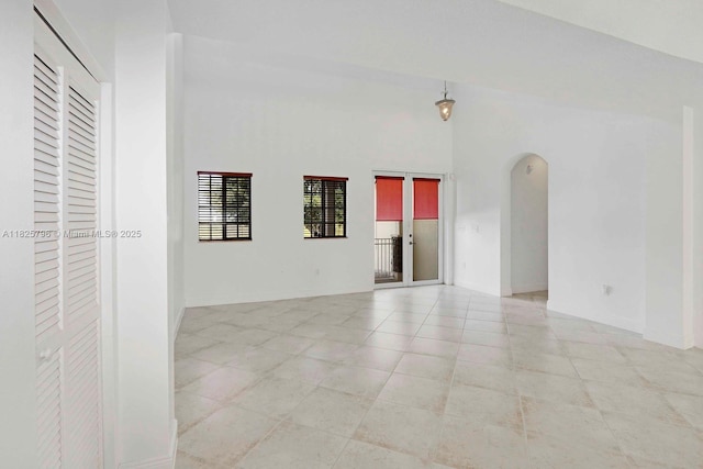 32157 SW 207th Ave, Homestead, FL 33030 - spare room with arched walkways and light tile patterned flooring