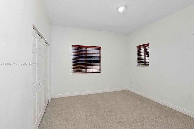 32157 SW 207th Ave, Homestead, FL 33030 - unfurnished bedroom featuring carpet floors, a closet, and multiple windows
