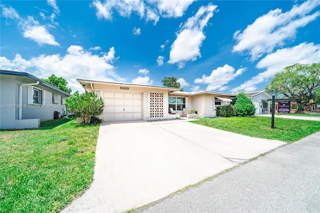 5103 NW 54th Ct, Tamarac, FL 33319 - ranch-style home with a garage, stucco siding, driveway, and a front yard