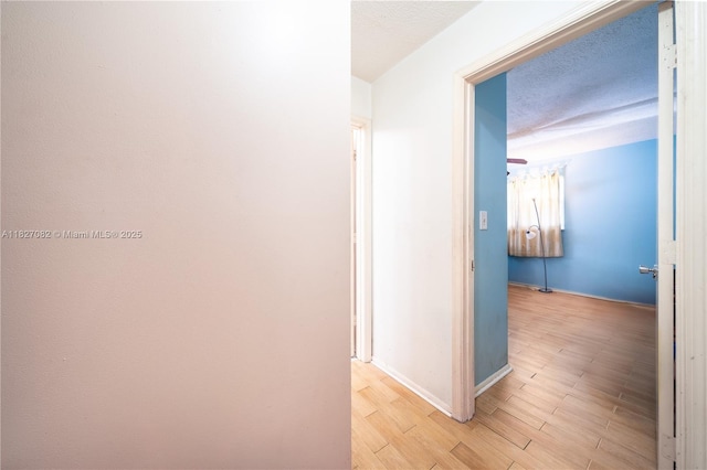 5103 NW 54th Ct, Tamarac, FL 33319 - hallway featuring light wood-type flooring and a textured ceiling