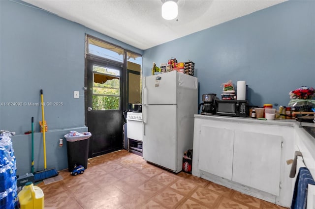 1616 SW 9th St, Fort Lauderdale, FL 33312 - kitchen featuring freestanding refrigerator, black microwave, and a ceiling fan