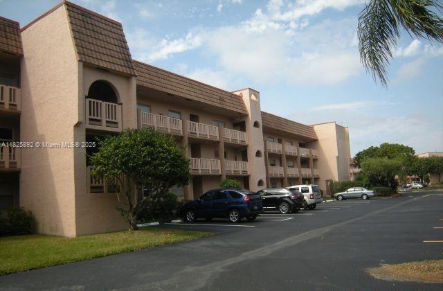 9841 Sunrise Lakes Blvd Unit 310, Sunrise, FL 33322 - view of apartment building / complex with uncovered parking