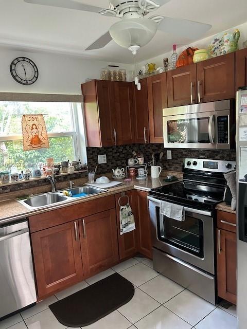9841 Sunrise Lakes Blvd Unit 310, Sunrise, FL 33322 - kitchen with stainless steel appliances, light tile patterned floors, and backsplash