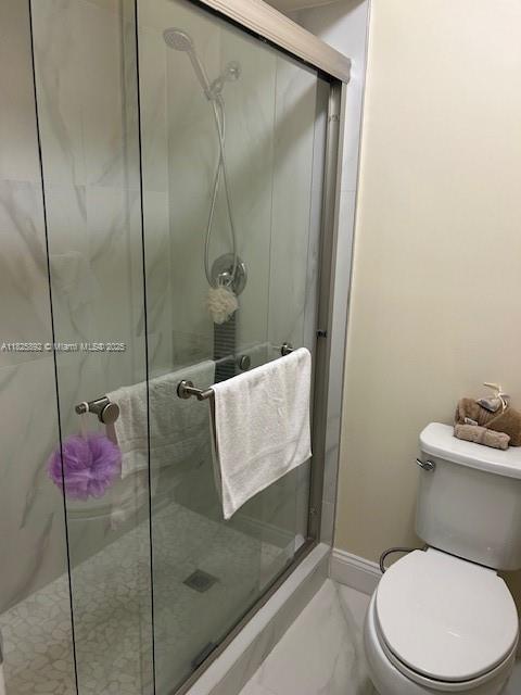 9841 Sunrise Lakes Blvd Unit 310, Sunrise, FL 33322 - full bathroom with marble look tiles and a stall shower