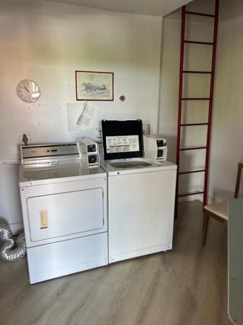 9841 Sunrise Lakes Blvd Unit 310, Sunrise, FL 33322 - community laundry room with wood finished floors and washing machine and clothes dryer